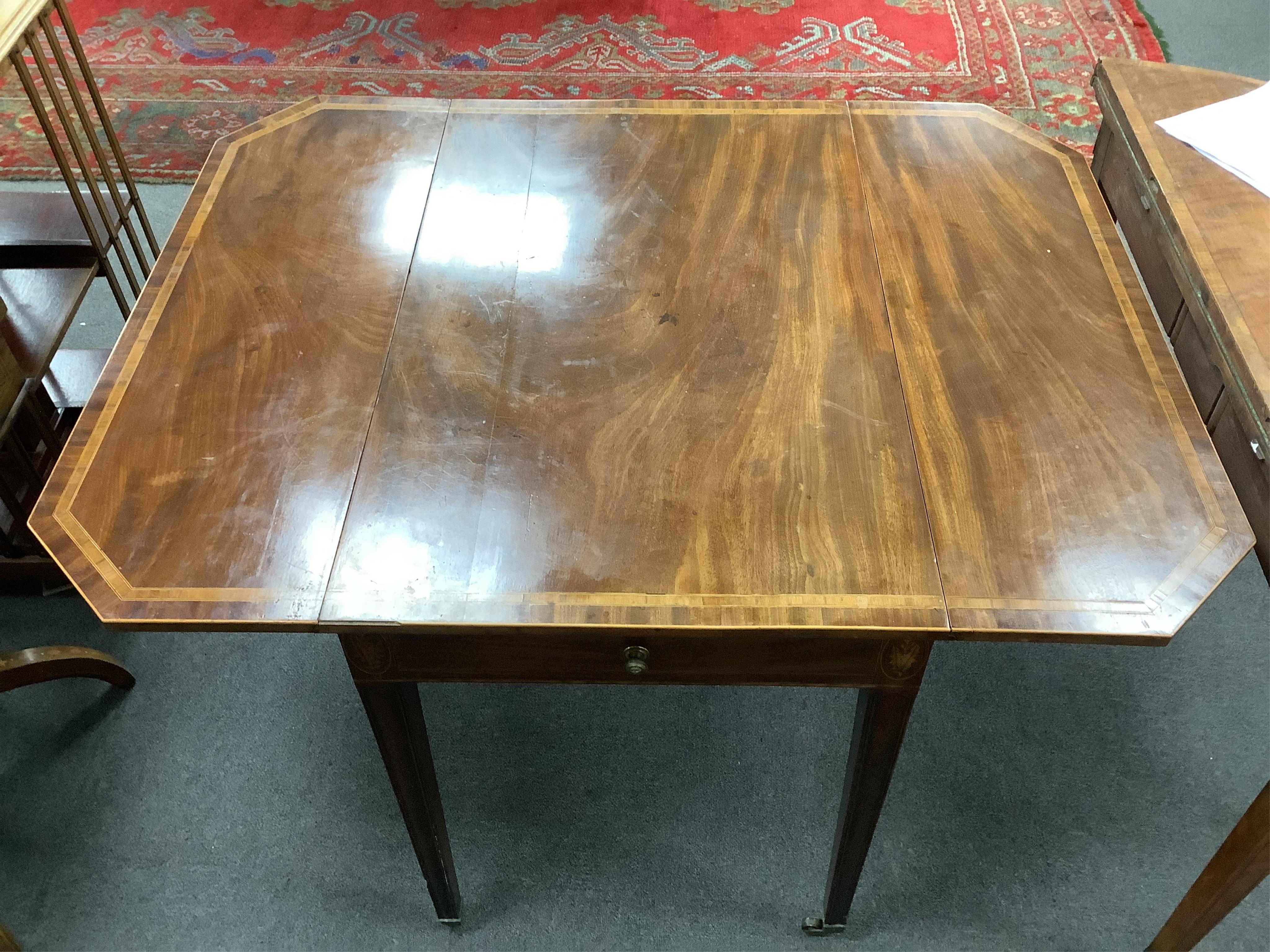 A George III crossbanded mahogany Pembroke table, with canted rectangular flaps and frieze drawer, on moulded squared tapered legs, fitted brass castors, 84cm wide, 54cm deep, 72cm high. Condition - overall of a slightly